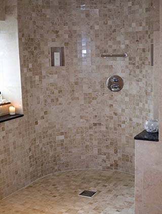 Finished walk-in shower in travertine mosaic