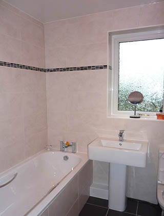 Cream bathroom with a mosaic border strip