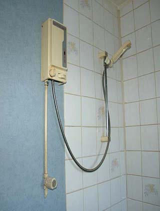 Old electric shower over the bath before the re-fit