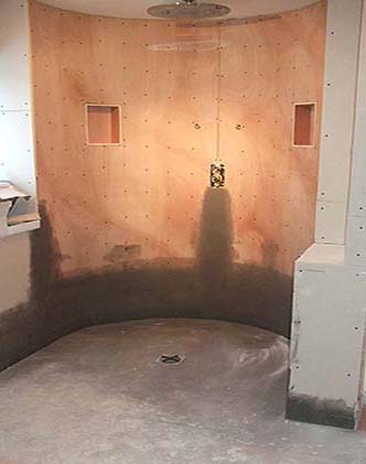 Curved shower wall boarded and prepared before tiling