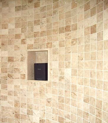 Finished travertine mosaic wall with a recessed niche